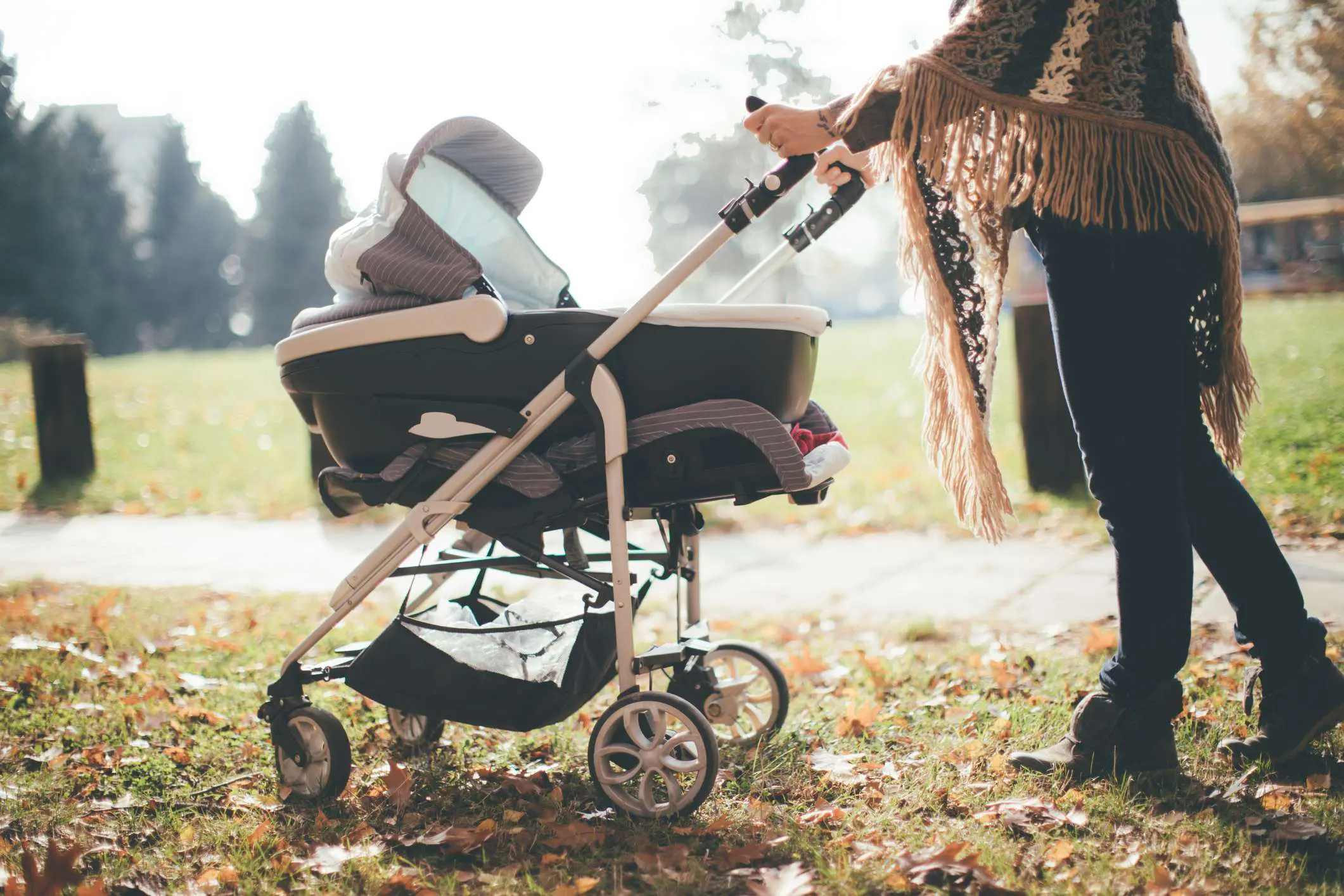 &nbsp;Young mother with a baby stroller